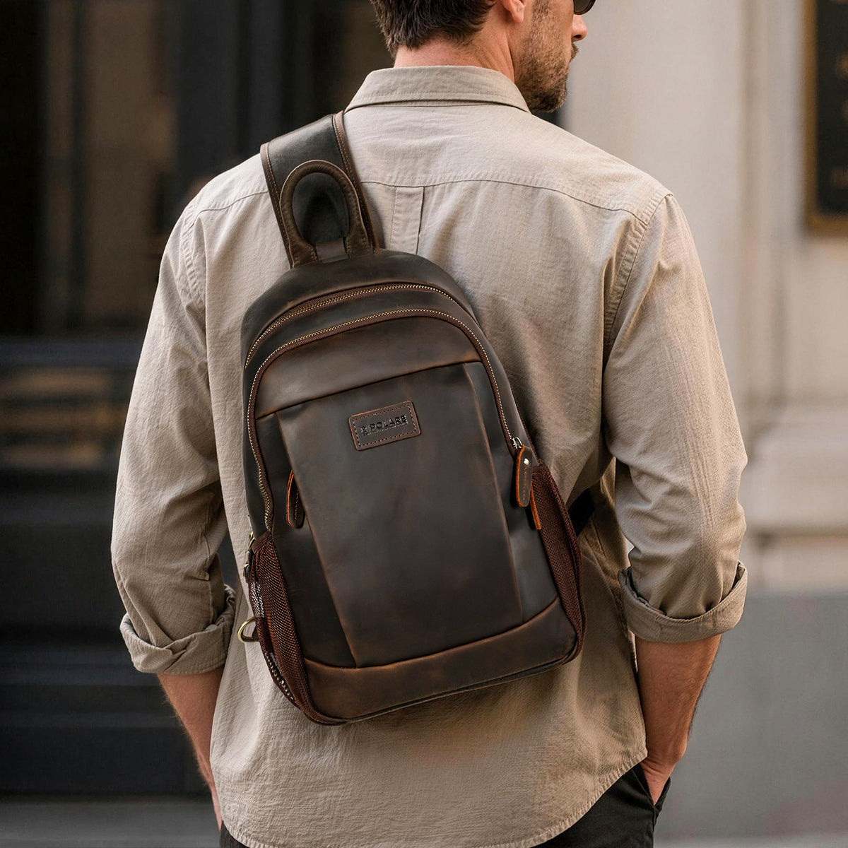 Man wearing a dark brown Polare full-grain leather sling bag across his back