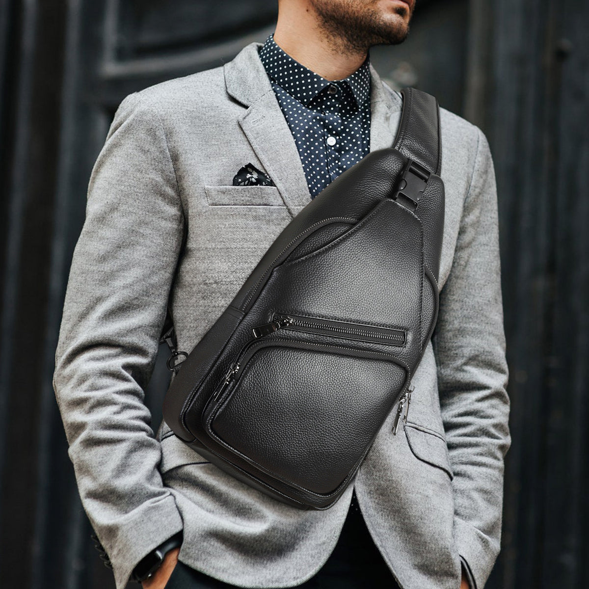 Man in a grey blazer wearing a black Polare leather crossbody chest bag